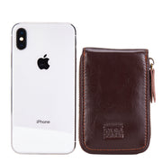 Brown Mercer leather card wallet shown beside a smartphone for scale