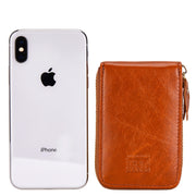 Orange Mercer leather card wallet shown beside a smartphone for scale