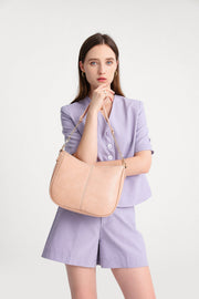 Pink | Woman carrying the Harper pink hobo shoulder bag with chain strap