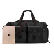 Green | Olive green waxed canvas travel duffel shown beside a tablet for scale