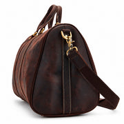 Dark Brown | Beaumont dark brown leather overnight duffel side view with adjustable shoulder strap