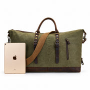 Green | Voyager green oversized travel duffel shown beside a tablet for scale