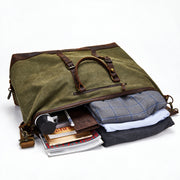 Green | Voyager green 50L duffel packed with clothing and travel essentials