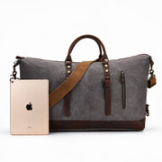 Gray | Voyager gray 50L travel duffel shown beside a tablet for scale