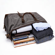 Gray | Voyager gray 50L duffel packed with clothing and travel essentials