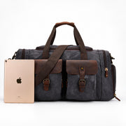 Gray | Gray weekender duffel shown beside a tablet for scale