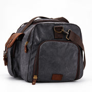 Gray | Gray waxed canvas duffel end view with zippered side storage