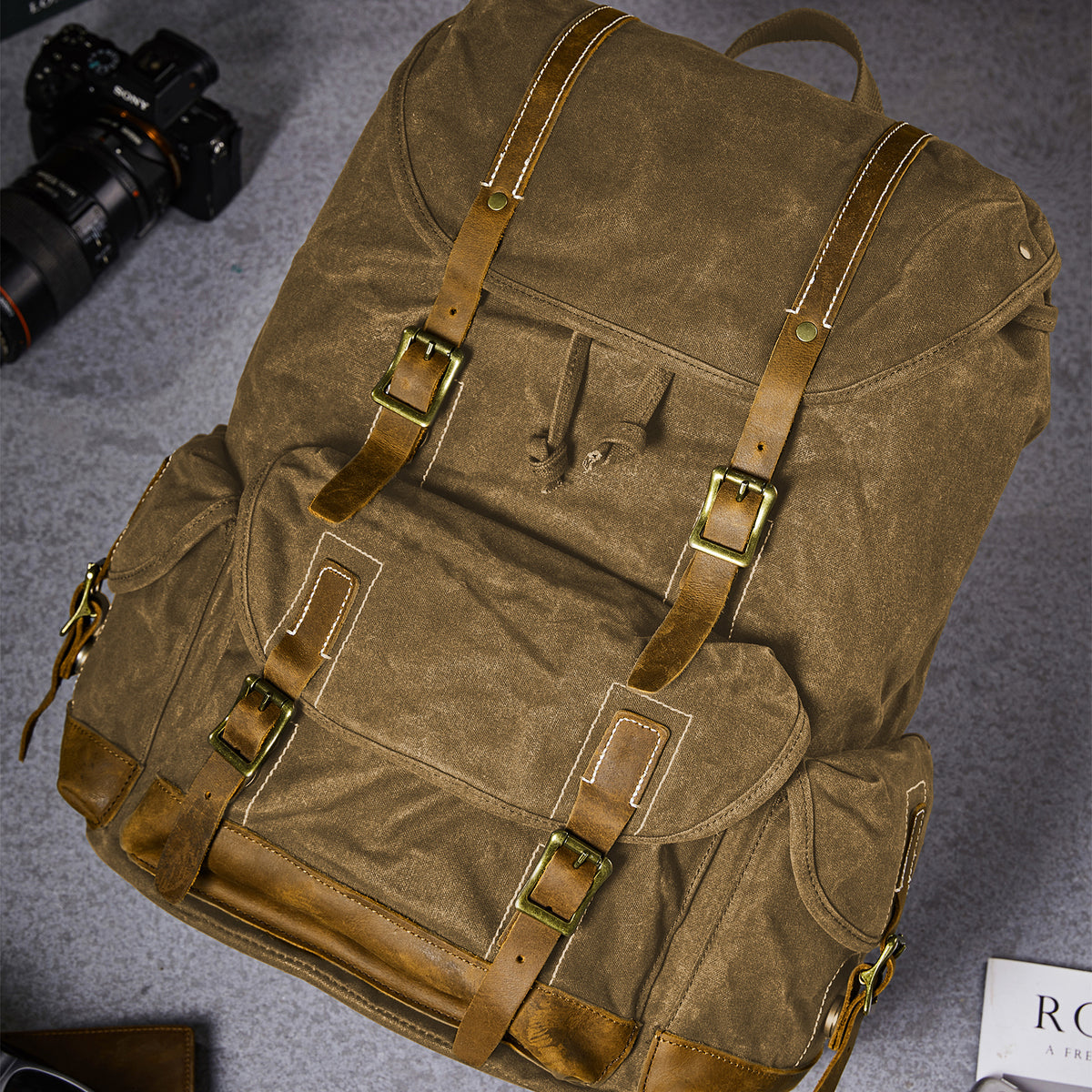 Coffee | Waxed canvas backpack leather straps and buckle details