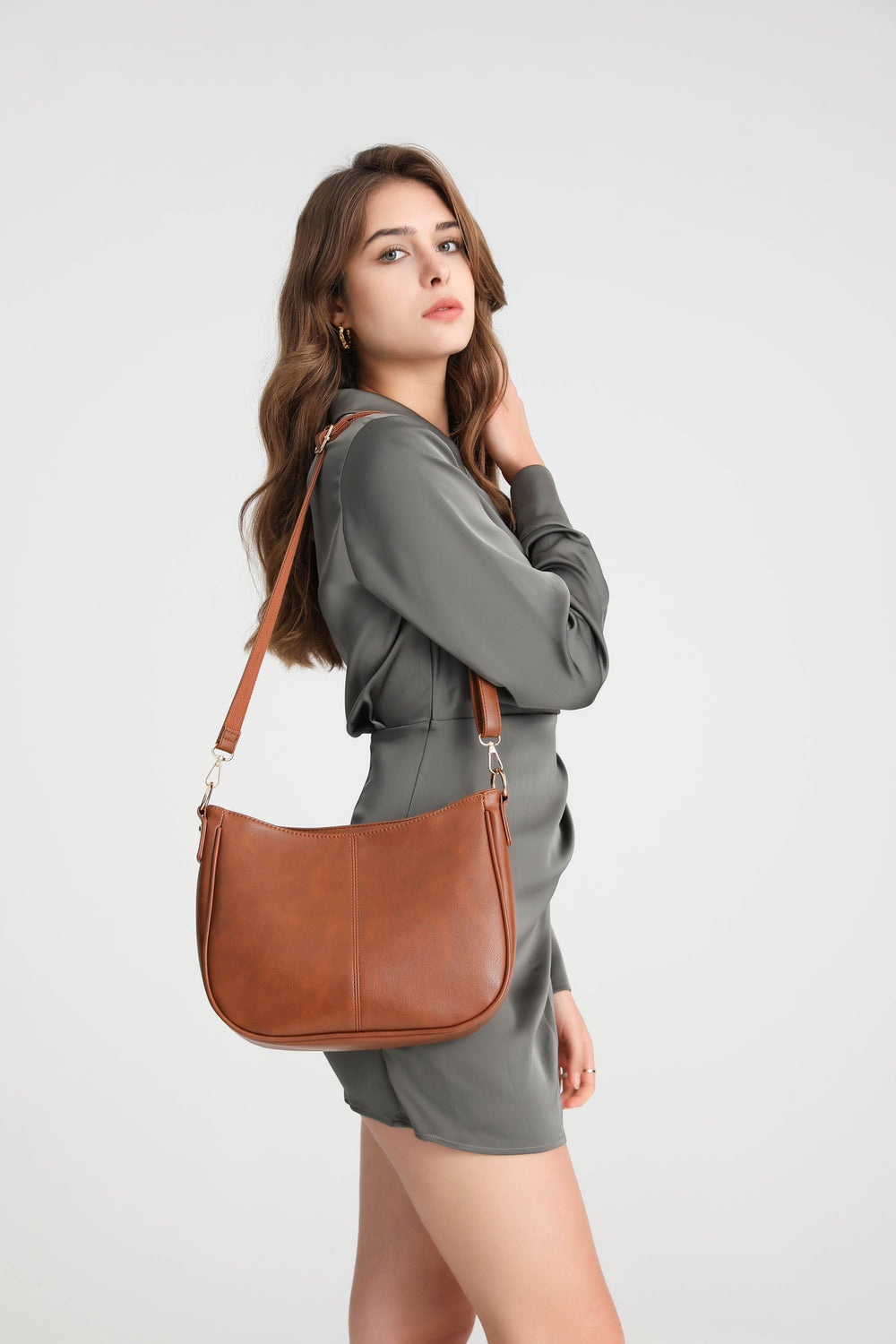 Brown | Woman carrying the Harper brown hobo bag with adjustable crossbody strap