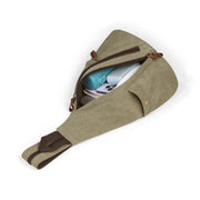 Brown | Atlas brown canvas sling backpack open with everyday essentials