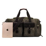 Green | Olive green waxed canvas duffel with tablet shown for size reference